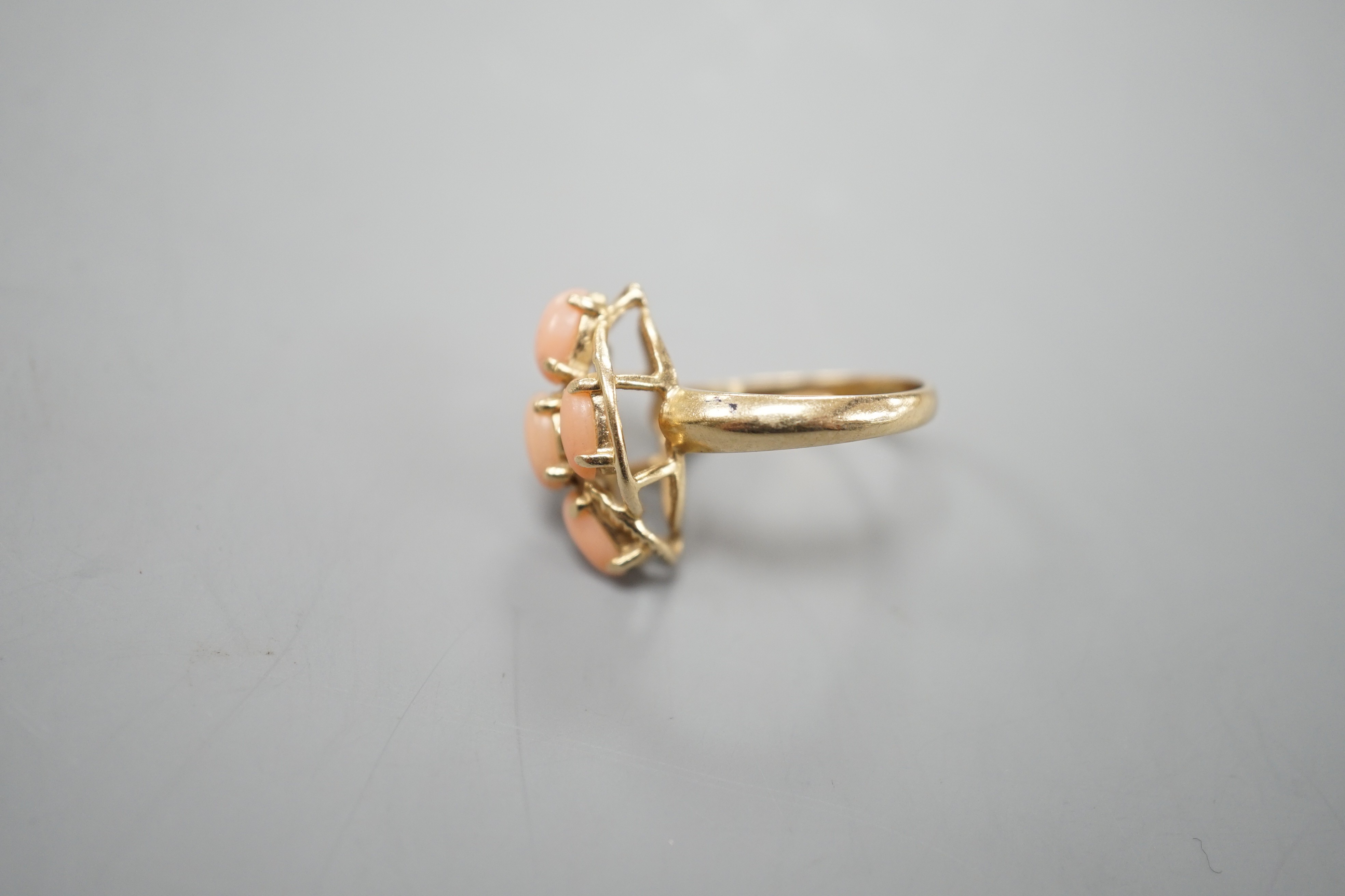 A modern 14k yellow metal and five stone oval coral bead set dress ring, size J/K, gross weight 2.9 grams.